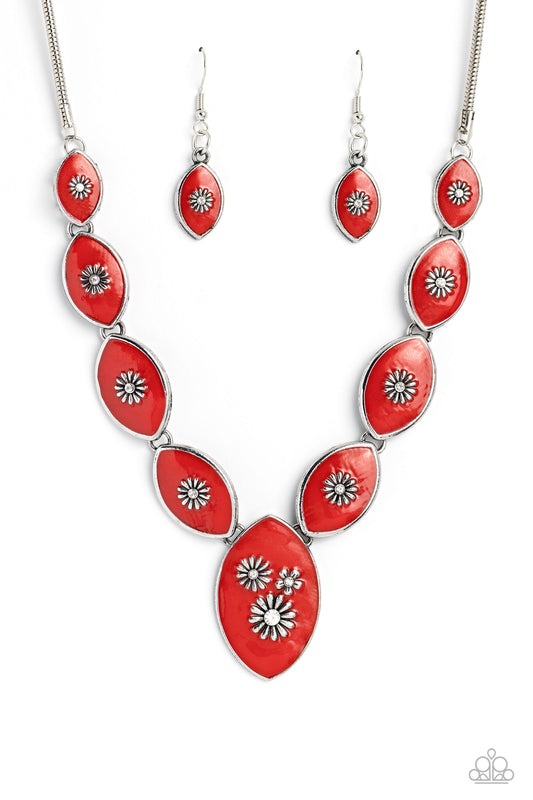 Featuring vibrant red paint, a collection of silver marquise-shaped frames gradually increase in size as they taper below the collar in a timeless fashion on a silver snake chain. Each frame is embossed with a delicate silver flower with a white rhinestone center, with the centermost pendant featuring three flowers, creating a glamorous array of whimsicality. Features an adjustable clasp closure.